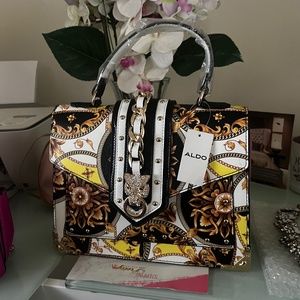Black, yellow, white and gold aldo bag with tiger stud buckle